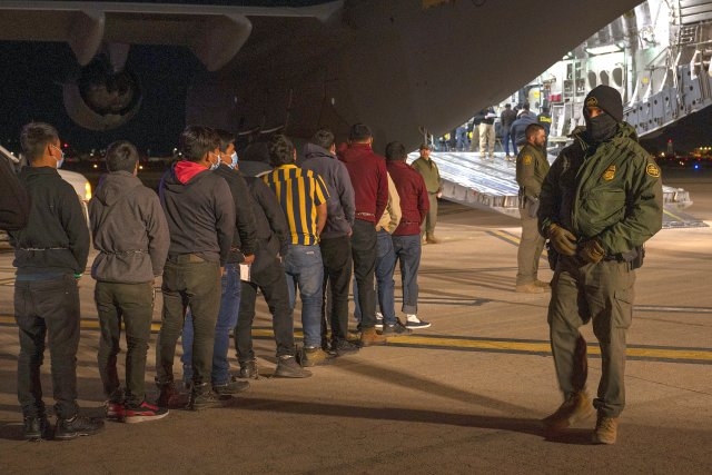 Handcuffed and Shackled, Illegal Migrants Head Home on U.S. Military Planes